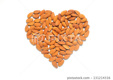 Almond heart on a white background. I love almonds. Healthy snack with nuts. Almond heart on a white background. I love almonds. Healthy snack with nuts. 131214316