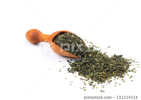 Green tea with herbs in wooden spoons on a White Background. 131214318