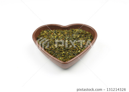 Green tea with herbs in wooden bowl on a White Background. 131214326