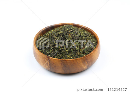 Green tea with herbs in wooden bowl on a White Background. 131214327
