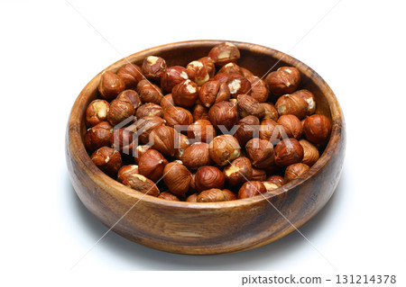 Wooden bowl full of hazelnuts on white background. Healthy eating concept. Super foods. Wooden bowl full of hazelnuts on white background. Healthy eating concept. Super foods. 131214378