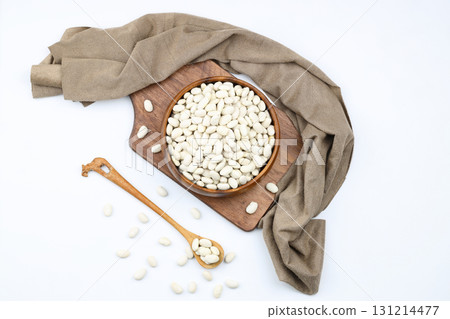 white kidney bean in wooden bowl isolated on white background. Top view. Flat lay white kidney bean in wooden bowl isolated on white background. Top view. Flat lay 131214477