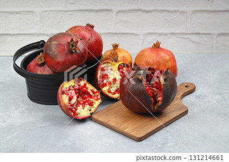 Ripe pomegranate fruit peeled on a white background top view close-up. Large open pomegranate fruit with large ripe grains isolated. Sliced exotic fruit. Ripe pomegranate fruit peeled on a white background top view close-up. Large open pomegranate fruit with large ripe grains isolated. Sliced exotic fruit. 131214661