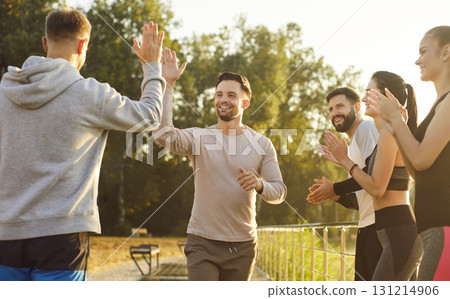 People high fiving and clapping, gathering outdoors in sunny park, support expressing joy People high fiving and clapping, gathering outdoors in sunny park, support expressing joy 131214906