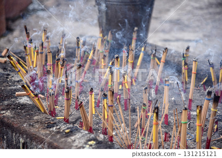 A stone pot with incense sticks and candles tied together. and is on fire There was a lot of smoke rising up. To worship holy things or ask for blessings from supernatural beings 131215121