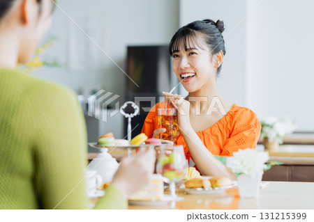 年輕女子在咖啡館享用下午茶 131215399