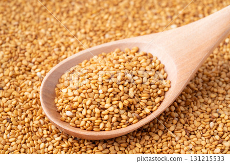 Close-up of golden sesame seeds (raw sesame seeds) on a spoon Close-up of golden sesame seeds (raw sesame seeds) on a spoon 131215533