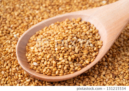 Close-up of golden sesame seeds (raw sesame seeds) on a spoon Close-up of golden sesame seeds (raw sesame seeds) on a spoon 131215534