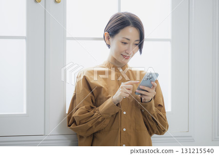 Woman holding a smartphone Woman holding a smartphone 131215540