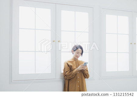 Woman holding a smartphone Woman holding a smartphone 131215542
