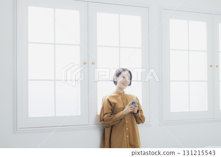 Woman holding a smartphone 131215543