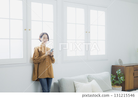 Woman holding a smartphone 131215546