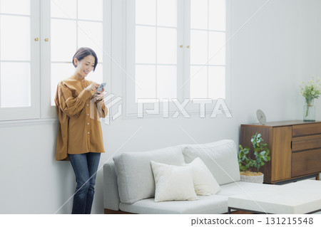 Woman holding a smartphone 131215548