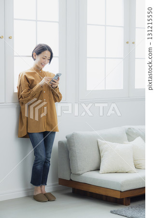 Woman holding a smartphone Woman holding a smartphone 131215550