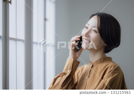 A woman who speaks with a smartphone 131215561