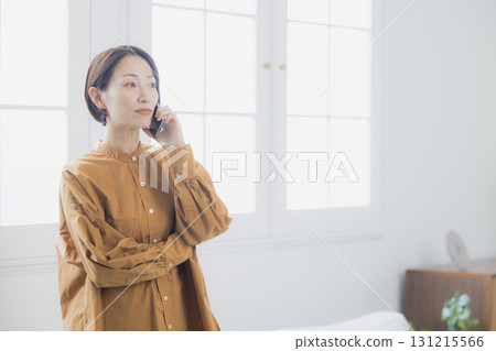 A woman who speaks with a smartphone 131215566
