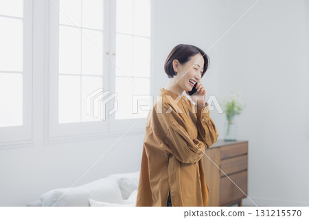 A woman who speaks with a smartphone 131215570