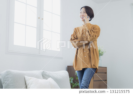 A woman who speaks with a smartphone 131215575