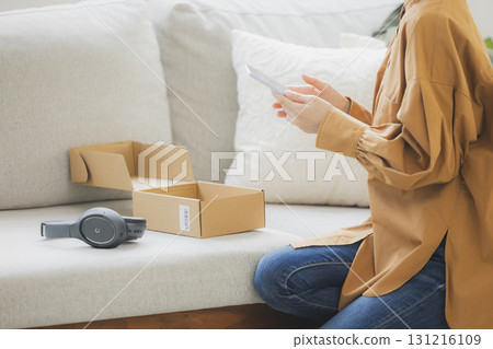 A woman selling items on a flea market app 131216109