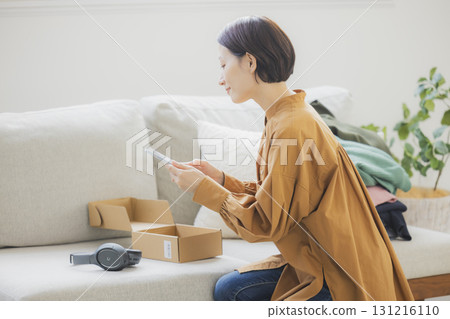 A woman selling items on a flea market app A woman selling items on a flea market app 131216110