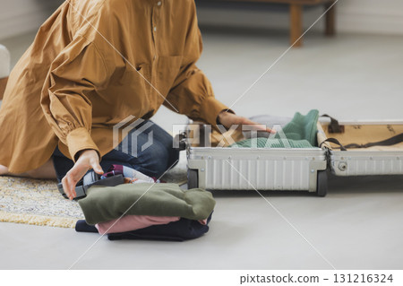 Middle-aged woman preparing for a trip 131216324