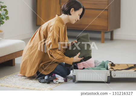 Middle-aged woman preparing for a trip 131216327