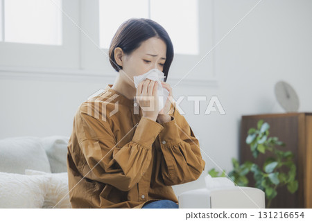 A woman with a cold wearing a mask 131216654