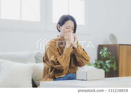 A woman with a cold wearing a mask 131216659