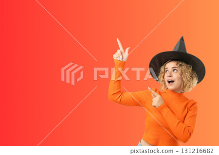 Young woman joyfully pointing in a festive Halloween setting Young woman joyfully pointing in a festive Halloween setting 131216682