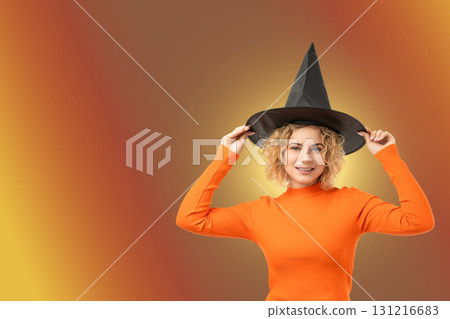 Woman in witch hat happily enjoying Halloween festivities Woman in witch hat happily enjoying Halloween festivities 131216683
