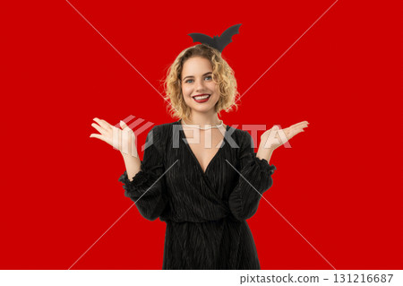 Woman joyfully interacts in Halloween attire with a festive vibe 131216687