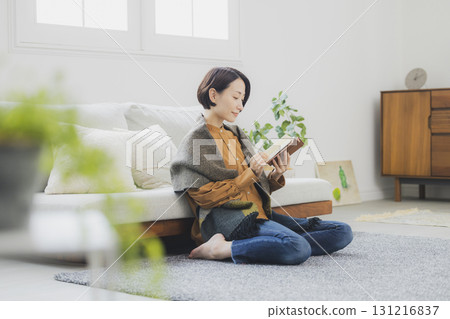 A woman reading on a sofa A woman reading on a sofa 131216837