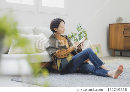 A woman reading on a sofa 131216838