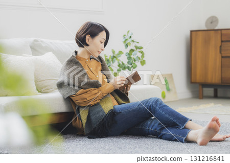 A woman reading on a sofa 131216841