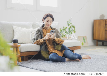 Woman holding a smartphone 131216975