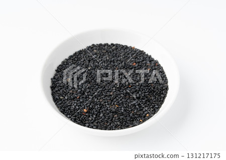 Black sesame seeds (raw sesame seeds) in a plate on a white background 131217175