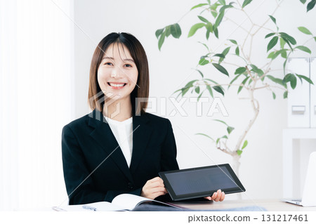 Business woman showing tablet 131217461