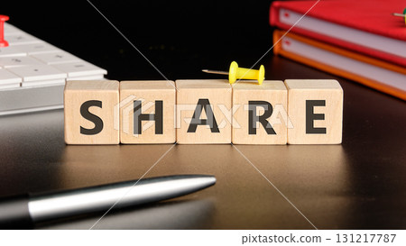 The concept word SHARE is collected of wooden cubes on a black background with stationery next to it. Technology, website concept 131217787