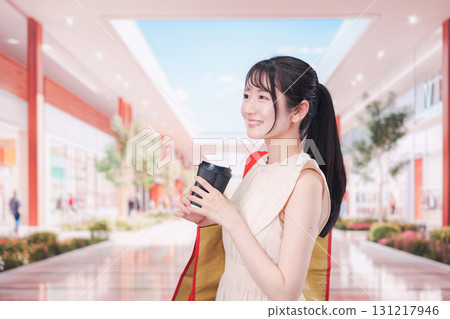 A woman drinking coffee and shopping at the mall A woman drinking coffee and shopping at the mall 131217946