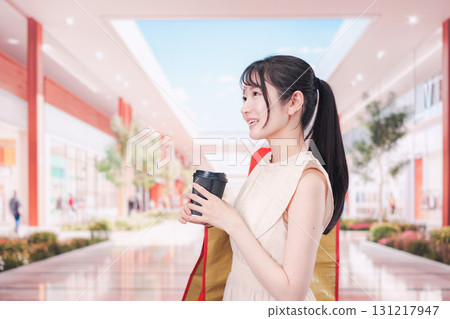 A woman drinking coffee and shopping at the mall 131217947