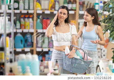Tired mother with capricious daughter in household chemicals store 131218220