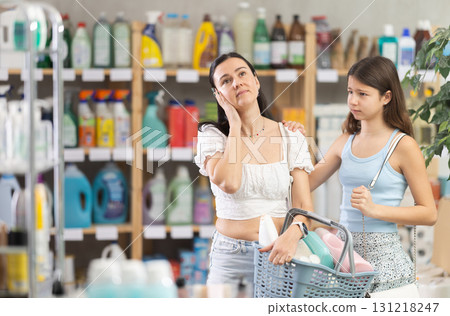 Tired mother and demanding daughter in supermarket cleaning aisle Tired mother and demanding daughter in supermarket cleaning aisle 131218247