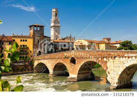 Summer view of Ponte Pietra and bell tower of Verona cathedral 131218379
