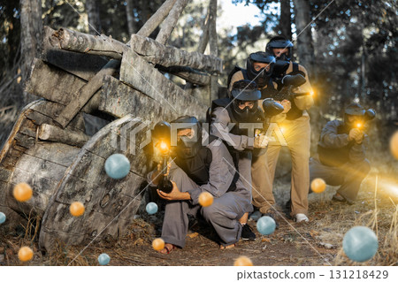 Team eliminating opponents on paintball field Team eliminating opponents on paintball field 131218429