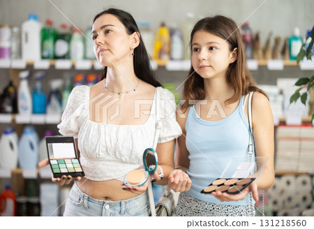 Woman with daughter choosing cosmetics in store Woman with daughter choosing cosmetics in store 131218560