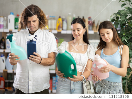 Interested family selecting household cleaning supplies in supermarket Interested family selecting household cleaning supplies in supermarket 131218596