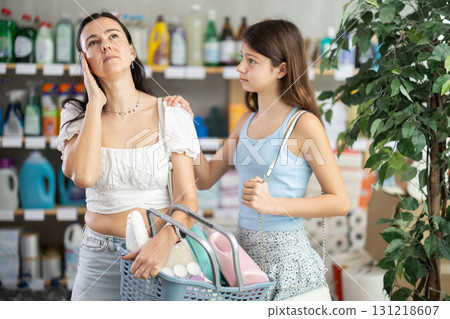 Tired mother with capricious daughter in household chemicals store Tired mother with capricious daughter in household chemicals store 131218607