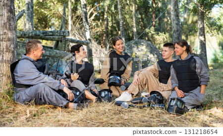 Team of paintball players discussing past game Team of paintball players discussing past game 131218654