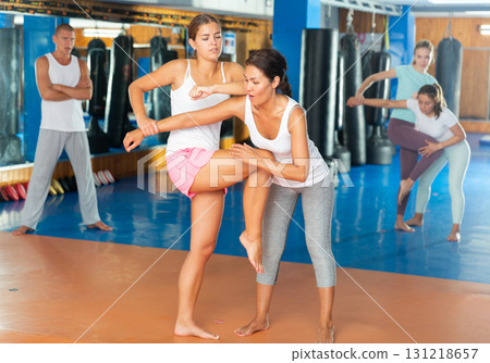 Sporty girls in pairs are training self-defence moves 131218657