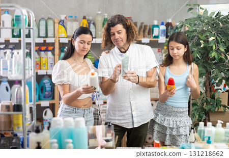 Family choosing sunscreen in supermarket 131218662